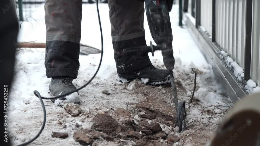 Builder Drills a hole in the wall with a Hammer Drill. Close-up of hammer drill perforator making hole Builder Drills a hole in the wall with a Hammer Drill. Close-up of hammer drill perforator making hole