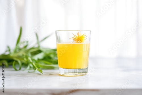 fresh dandelion detox juice in a clear glass