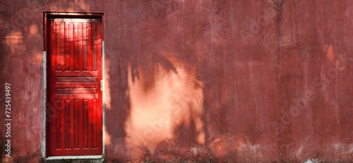 old house with red door and rustic wall