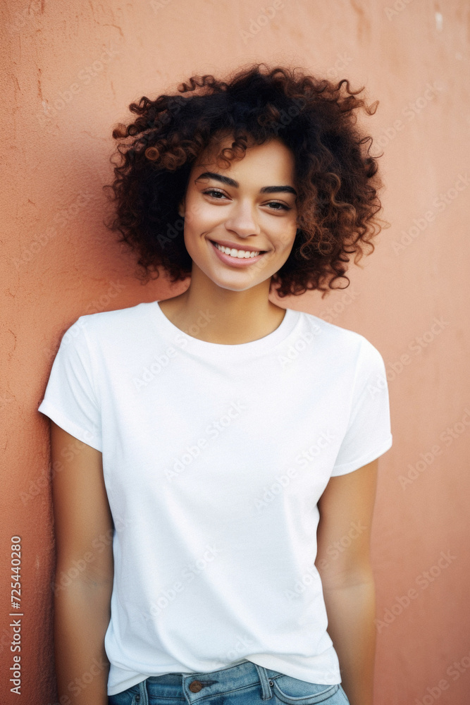 Young happy smiling Latin woman model wearing tshirt standing on color background. Face skin treatment, curly hair care cosmetics makeup, fashion ads. Beauty portrait. White t-shirt mock up template . Young happy smiling Latin woman model wearing tshirt standing on color background. Face skin treatment, curly hair care cosmetics makeup, fashion ads. Beauty portrait. White t-shirt mock up template .
