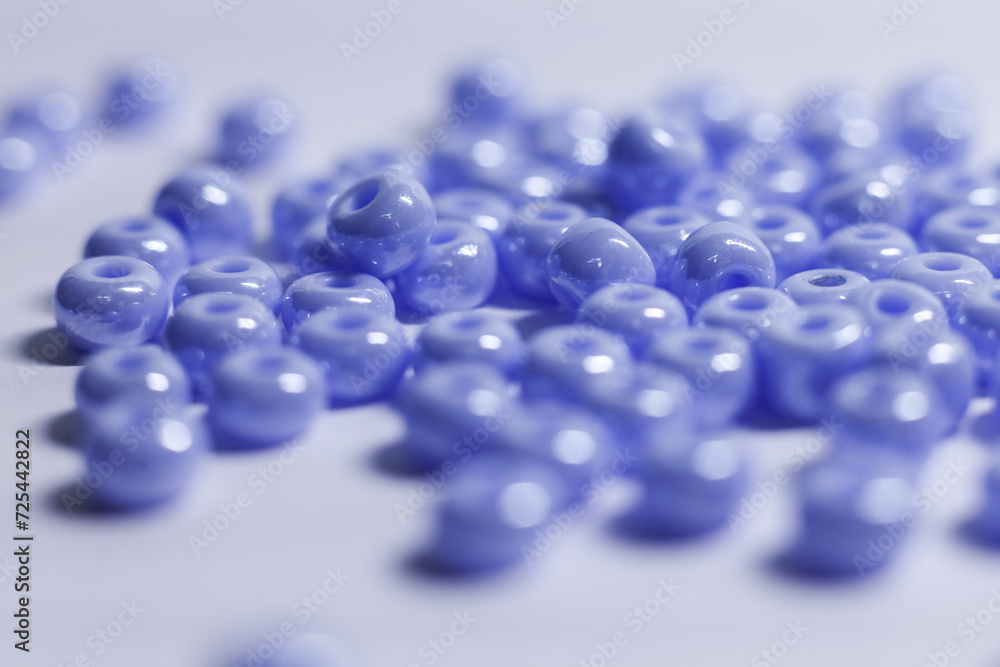 a bunch of blue beads on a white surface a bunch of blue beads on a white surface