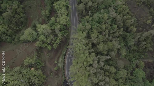 Aerial view, winding road to Mangunan peak tourist attraction. it looks beautiful and to the right there are dense hills. photo