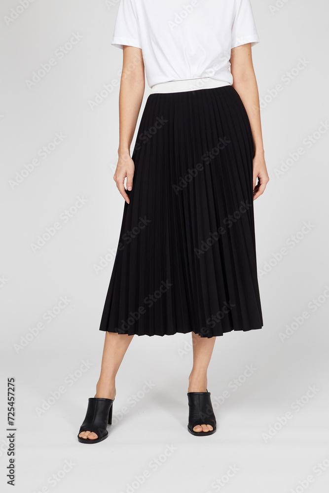 Black women's luxury Classic Long Maxi pleated skirt on model isolated on white background. Woman wearing Midi folded Accordion Skirt, summer autumn outfit. Top view. Template, concept Black women's luxury Classic Long Maxi pleated skirt on model isolated on white background. Woman wearing Midi folded Accordion Skirt, summer autumn outfit. Top view. Template, concept