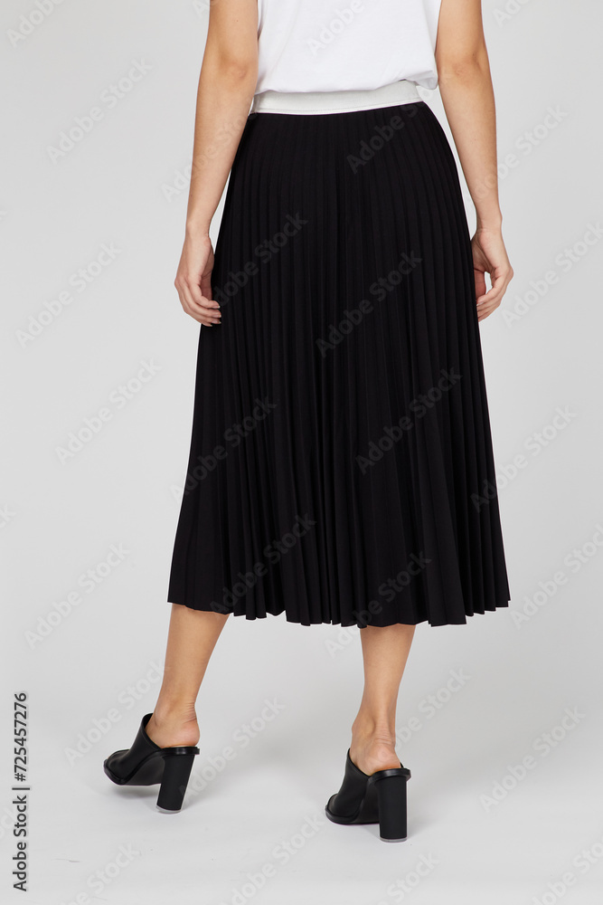Black women's luxury Classic Long Maxi pleated skirt on model isolated on white background. Woman wearing Midi folded Accordion Skirt, summer autumn outfit. Back view. Template, concept Black women's luxury Classic Long Maxi pleated skirt on model isolated on white background. Woman wearing Midi folded Accordion Skirt, summer autumn outfit. Back view. Template, concept