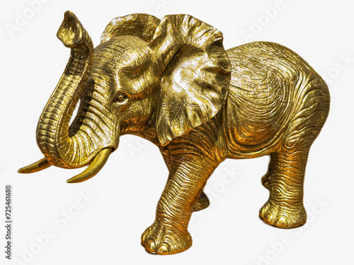 Golden elephant on white background with big ears and tusks beautifully raised trunk. Symbol of good luck and fulfillment of wishes.