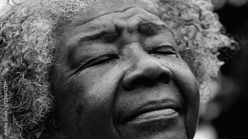 Wallpaper Mural One thoughtful senior black woman closing eyes in tranquil meditation, Soulful African American person in 80s tracking close-up face shot gazing upwards to divinity, monochromatic Torontodigital.ca