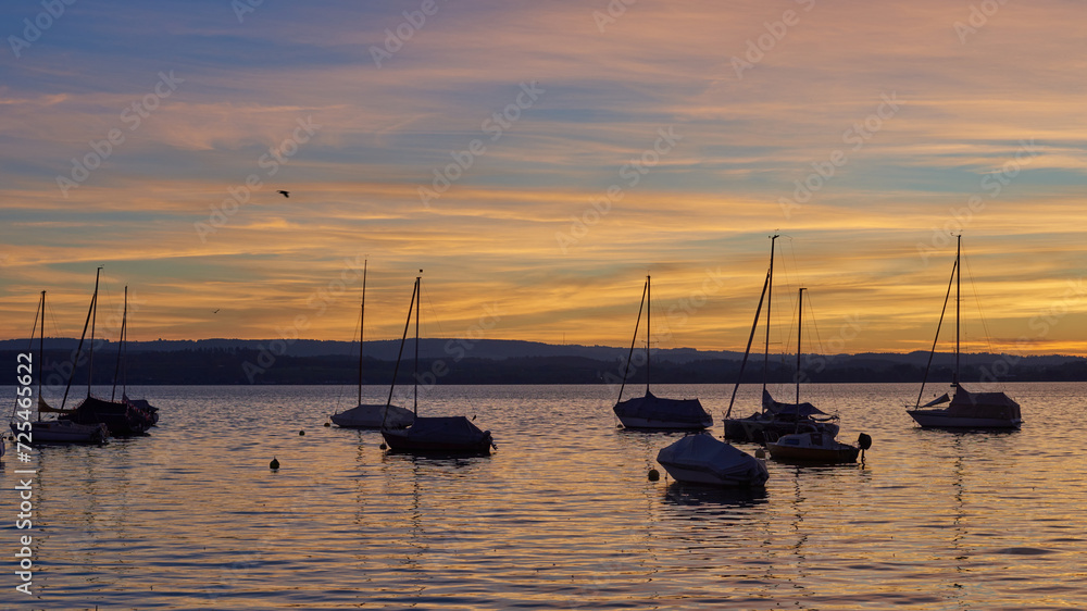 Bodensee Lake Sunset Panorama. Evening Sunlight Over Tranquil Waters. Sunset Vista at Lake Bodensee in Germany. Bodensee Lake Sunset Panorama. Evening Sunlight Over Tranquil Waters. Sunset Vista at Lake Bodensee in Germany.