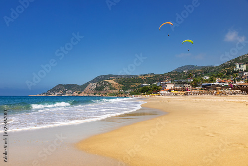 Fototapeta Naklejka Na Ścianę i Meble -  Paragliders soaring above Kleopatra Beach Alanya Turkey