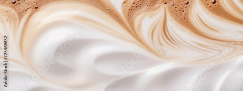 A close-up of the surface of a latte mixed with coffee and milk to be used as a banner.