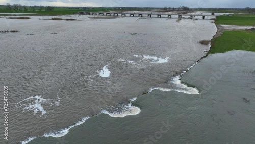 Water from the river Ijssel running into the Reevediep bypass for the first time aerial view near Kampen city during winter in Overijssel, Netherlands photo