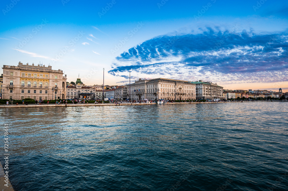Dusk and night in Trieste. Between historic buildings and the sea.
