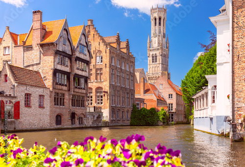 Scenic sunny medieval fairytale town and tower Belfort from the quay Rosary in Bruges, Belgium