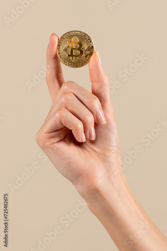 Female hand showing bitcoin in studio
