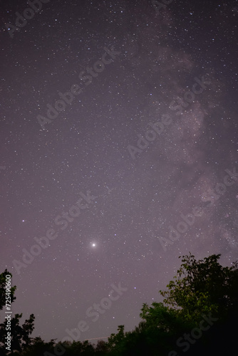 Planets Jupiter and Saturn on summer night sky with milky way galaxy shining trough millions of stars 