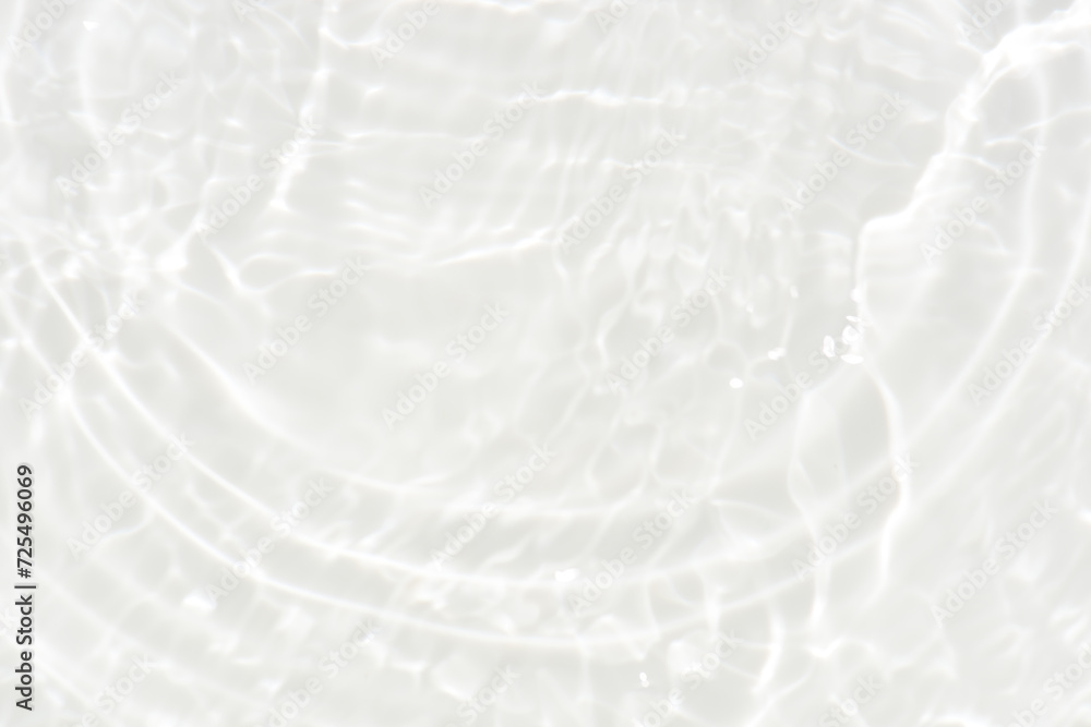 Obraz premium White water with ripples on the surface. Defocus blurred transparent white colored clear calm water surface texture with splashes and bubbles. Water waves with shining pattern texture background.