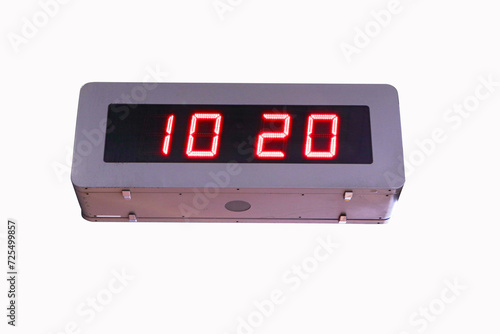 Digital clock time LED red number on black digital electric brown wooden border isolated on white background. Time symbol concept for celebrating the New Year. At Time 10.20 AM.