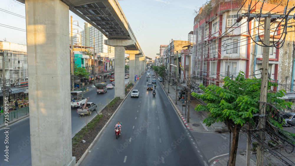 23 December 2023 in Bangkok, Thailand There are 2 types of road travel: both above ground and 2 electric train routes that are used together. There are many cars running on the road.