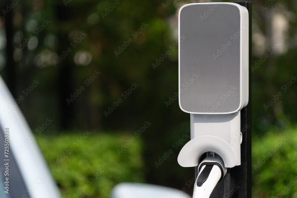 Closeup EV charging station with electric charger plug connected to ...