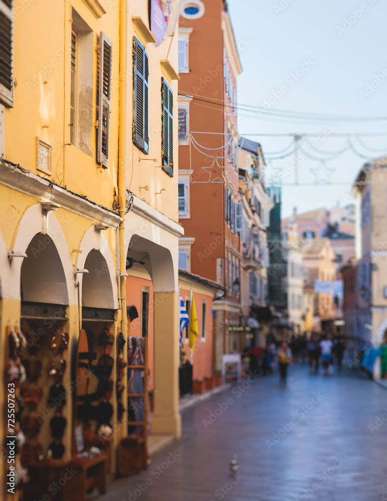 Obraz premium Corfu street view, Kerkyra old town beautiful cityscape, Ionian sea Islands, Greece, a summer sunny day, pedestrian streets with shops and cafes, architecture of historic center, travel to Greece