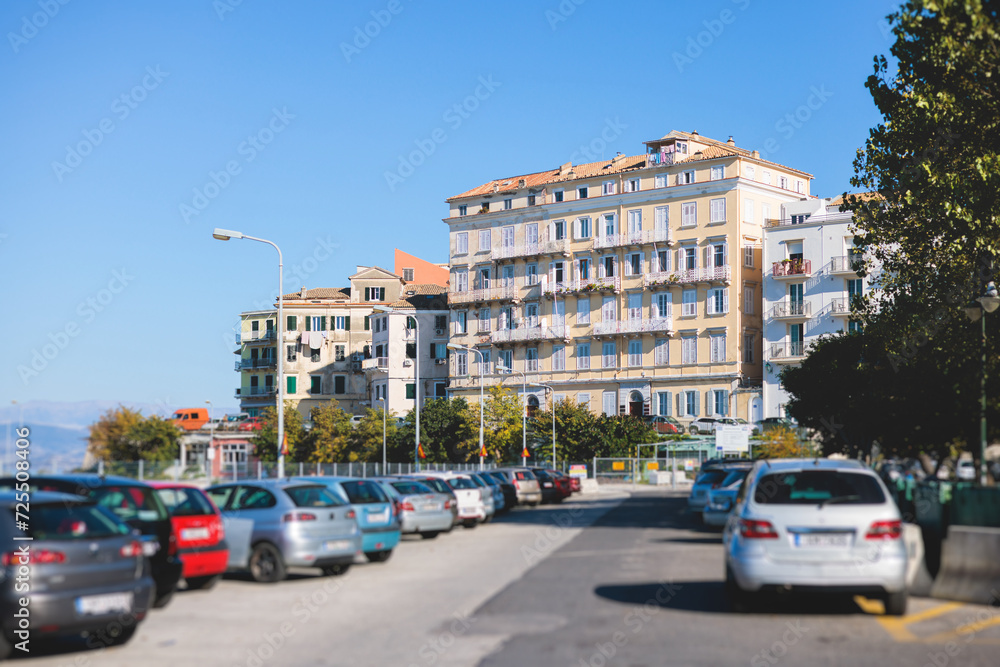 Fototapeta premium Corfu street view, Kerkyra old town beautiful cityscape, Ionian sea Islands, Greece, a summer sunny day, pedestrian streets with shops and cafes, architecture of historic center, travel to Greece