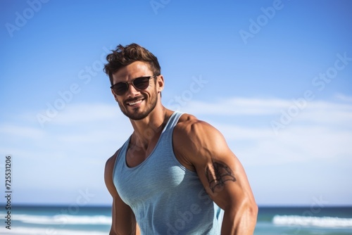 Portrait of a handsome young man with sunglasses on the beach.