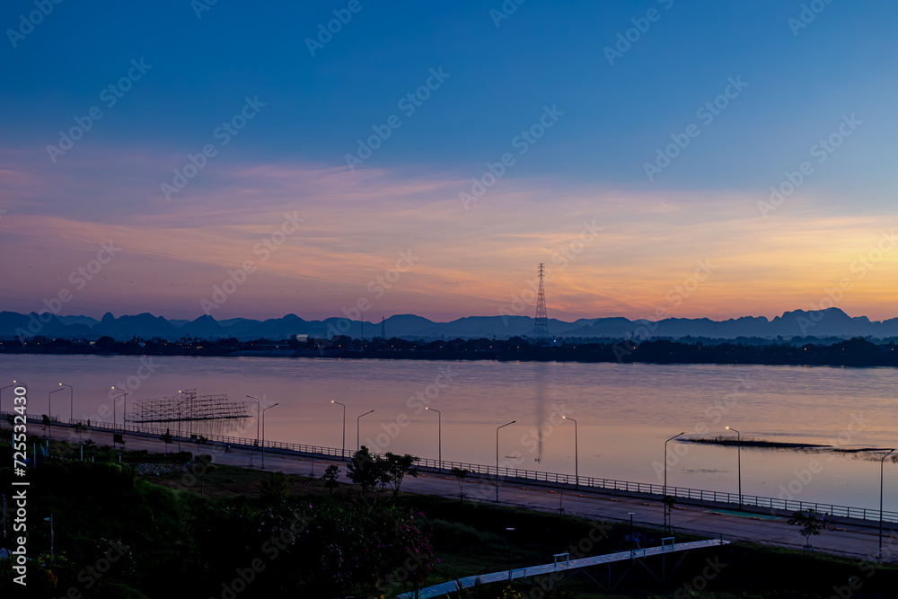 Landscape view of Mekong river during twilight time in evening, Riverside between Thai and Laos border, Small villages on the other side, Nakhon Phanom province, Northeastern Thailand also called Isan