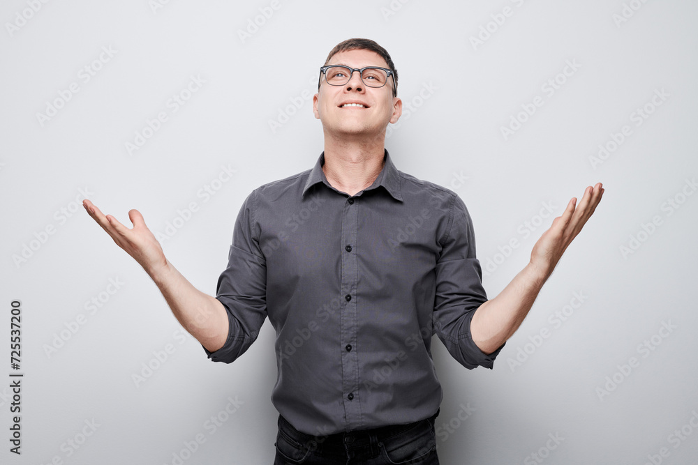 Portrait man happy face smiling joyfully with raised palms and shocked open mouth isolated on white studio background. Portrait man happy face smiling joyfully with raised palms and shocked open mouth isolated on white studio background.