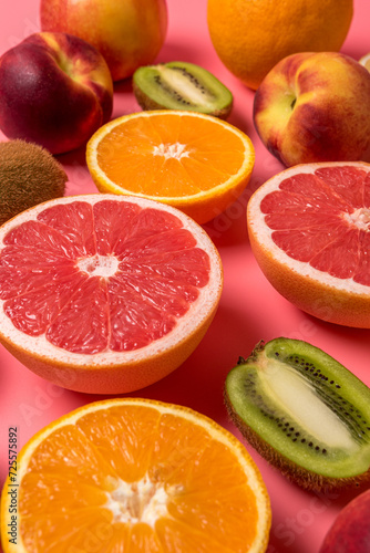 Creative fruit composition on pink background with hard shadows. Summer minimal concept.