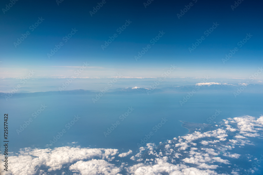 view from the airplane window landscape above the clouds view from the airplane window landscape above the clouds