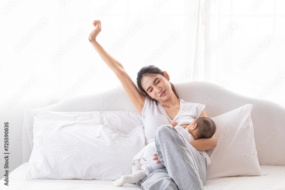 Selective focus young Asian beautiful mother hold newborn baby 0-1 month in her arms with love, gently, infant happy sleeping mom looking infant , newborn baby feeling secure while sleeping in mom arm Selective focus young Asian beautiful mother hold newborn baby 0-1 month in her arms with love, gently, infant happy sleeping mom looking infant , newborn baby feeling secure while sleeping in mom arm