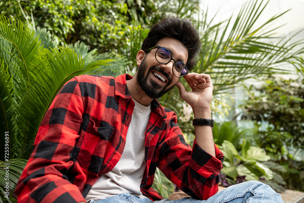Contented young hindu man in plaid shirt Contented young hindu man in plaid shirt