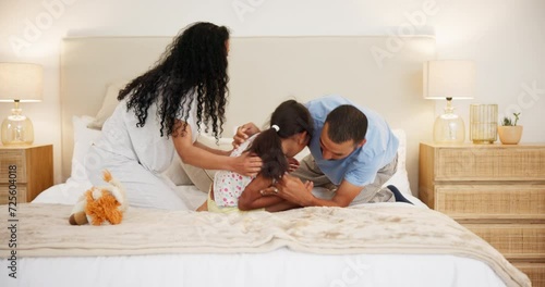 Parents, child and jumping on bed to play, silly games and bonding together on vacation in home. Man, woman or daughter with tickling in bedroom, wellness or weekend away for fun in holiday apartment photo