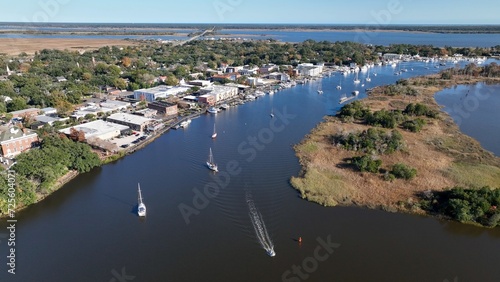 Cars and boats in small town USA historic Georgetown, SC with front street business and homes by Winyah Bay waterway in South Carolina Low Country