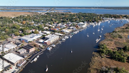 Cars and boats in small town USA historic Georgetown, SC with front street business and homes by Winyah Bay waterway in South Carolina Low Country