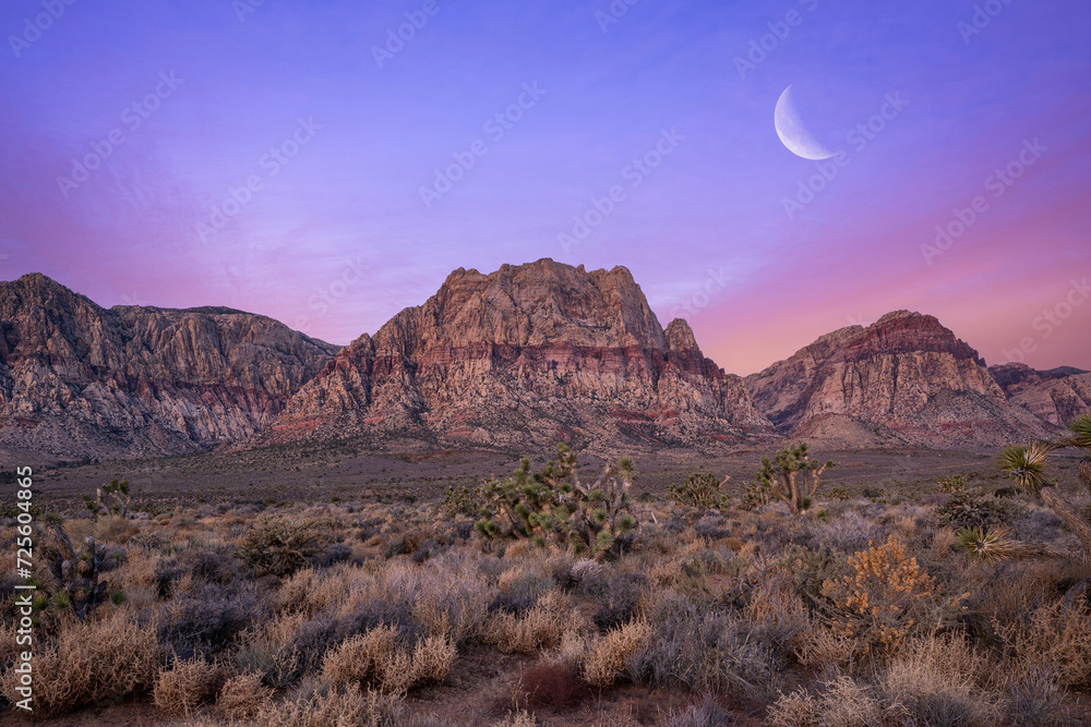 Dawn moonrise over mountain ranges in Red Rock Canyon Nevda 
