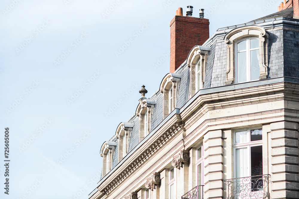 Facade of a beautiful old tenement house in France, historic French architecture.