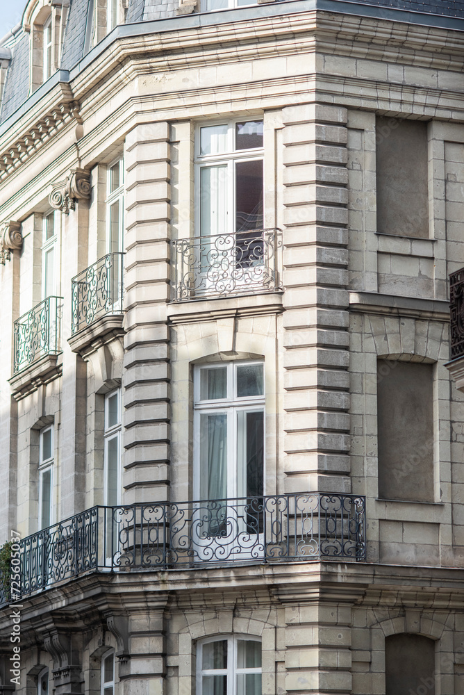 Facade of a beautiful old tenement house in France, historic French architecture.