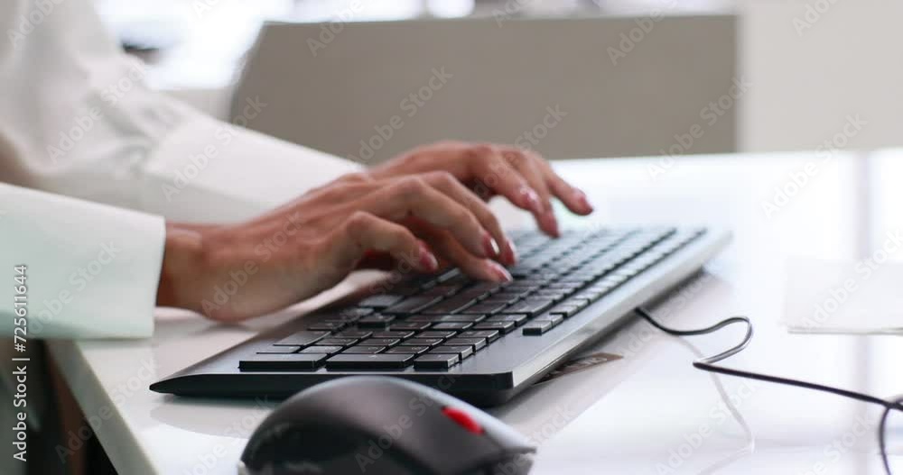 Close up hand woman typing on keyboard computer. airline employee is keying passenger information into a computer. Close up hand woman typing on keyboard computer. airline employee is keying passenger information into a computer.