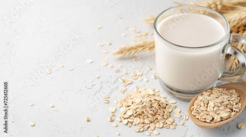 Nutritious oat milk with whole oats and wheat on a neutral backdrop, alternative vegan plant-based milk