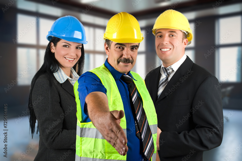 Group of three engineers with helmets Group of three engineers with helmets