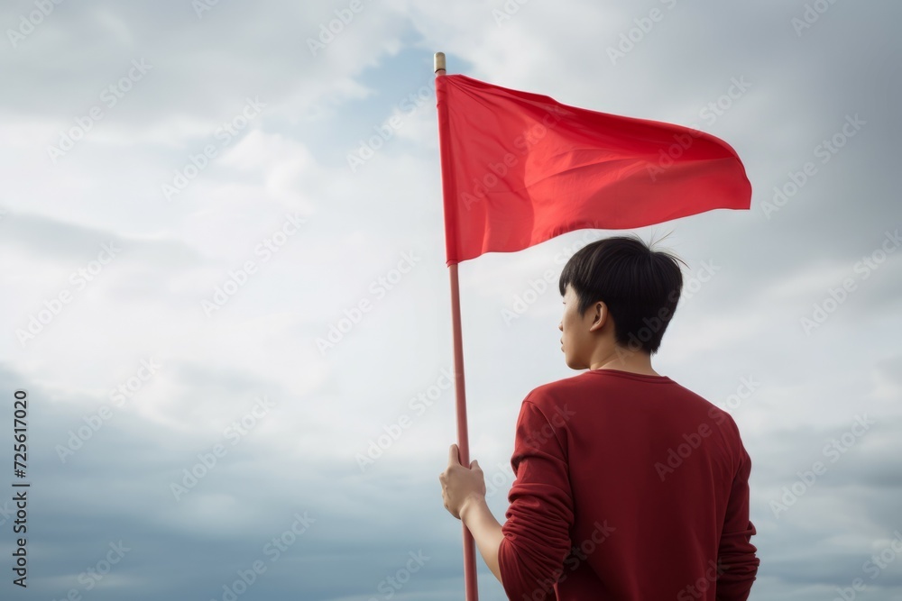 Alone man with red flag. Thoughtful and youth person holding scarlet flagship. Generate AI Alone man with red flag. Thoughtful and youth person holding scarlet flagship. Generate AI