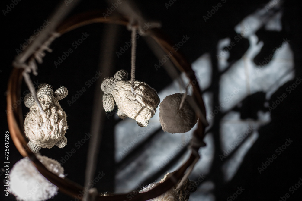 two small balls hanging from the side of a wire,