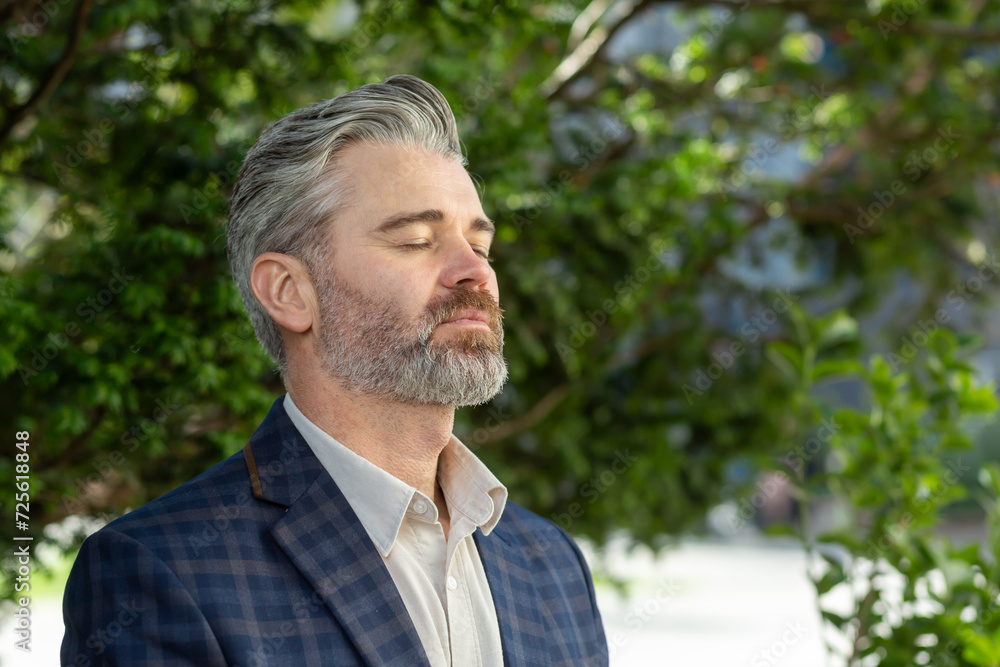 Contemplative senior executive in a business suit stands outside an office building, exuding professionalism and experience. Contemplative senior executive in a business suit stands outside an office building, exuding professionalism and experience.