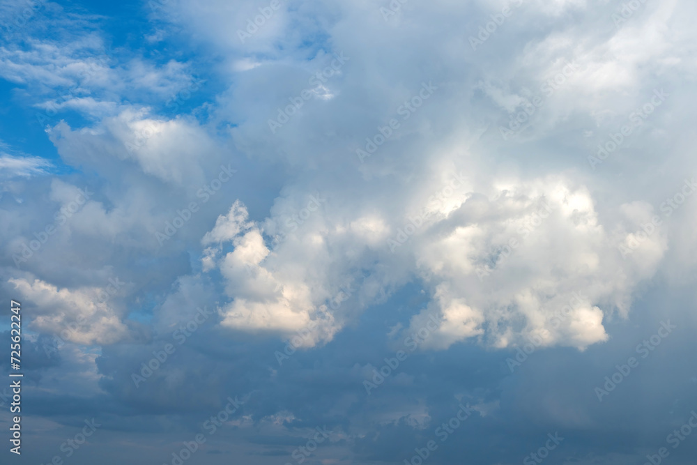 White and grey fluffy cloud on blue sky background texture. Heavy storm cumulus cloud. Copy space White and grey fluffy cloud on blue sky background texture. Heavy storm cumulus cloud. Copy space