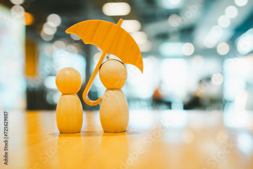 Umbrella icon and family model, Security protection and health insurance. The concept of family home, protection, health care day, car insurance.