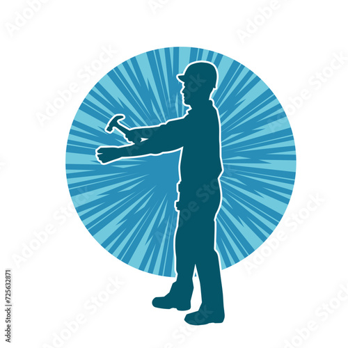 Silhouette of a worker carrying hammer tool. Silhouette of a worker in action pose using hammer tool.
