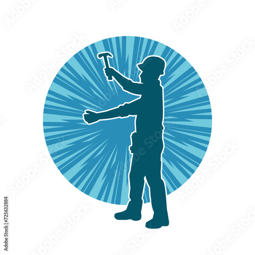 Silhouette of a worker carrying hammer tool. Silhouette of a worker in action pose using hammer tool.

