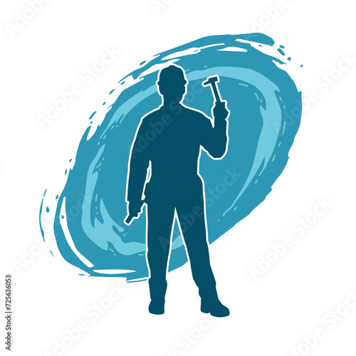 Silhouette of a worker carrying hammer tool. Silhouette of a worker in action pose using hammer tool.
