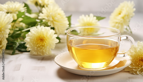 Chrysanthemum flower tea in glass cup with flowers. Refreshing healthy beverage for drink. Herbs and medical concept