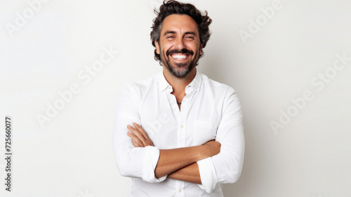 Portrait of a happy latin man with arms crossed against white background